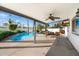 Covered patio overlooking a sparkling pool, outdoor seating, and TV perfect for entertaining at 10052 N 77Th St, Scottsdale, AZ 85258