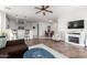 Open living room with tile flooring, kitchen bar and fireplace, creating an inviting and spacious atmosphere at 1015 E Pasture Canyon Dr, San Tan Valley, AZ 85143