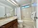 Bathroom featuring a granite countertop vanity, bathtub with white tile surround and new fixtures at 1016 E Utopia Rd, Phoenix, AZ 85024