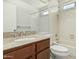 Clean bathroom with a shower-tub combo, white tile, and a granite-topped vanity at 1016 E Utopia Rd, Phoenix, AZ 85024