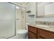 Modern bathroom with a glass-enclosed shower, granite countertop and wood vanity at 1016 E Utopia Rd, Phoenix, AZ 85024