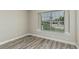 Bedroom with neutral walls, wood floors, and a bright window at 1016 E Utopia Rd, Phoenix, AZ 85024