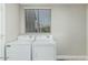 Bright laundry room featuring neutral tones, a window, and white washer and dryer at 1016 E Utopia Rd, Phoenix, AZ 85024