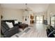Inviting living room with a large leather sofa, modern fan, and bright natural light at 1016 E Utopia Rd, Phoenix, AZ 85024