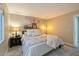 Spacious main bedroom with large bed, carpeted floor, stylish light fixture, and art on the wall at 1016 E Utopia Rd, Phoenix, AZ 85024