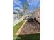 Charming backyard featuring a brick patio, lush artificial turf, a privacy fence, and an inviting outdoor seating area at 102 W Washington Ave, Gilbert, AZ 85233