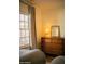 Relaxing bedroom featuring natural lighting from large windows and a vintage wooden dresser with mirror at 102 W Washington Ave, Gilbert, AZ 85233