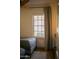 Bedroom with hardwood floors, neutral gray tones, and natural light from a large window at 102 W Washington Ave, Gilbert, AZ 85233