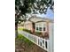 A view of the house from behind a white picket fence featuring bay windows and flower boxes at 102 W Washington Ave, Gilbert, AZ 85233