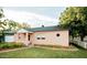 Side view of charming light pink home with manicured lawn and greenery surrounding the house at 102 W Washington Ave, Gilbert, AZ 85233