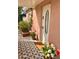Inviting front porch features black and white patterned tiles and red and white potted flowers at 102 W Washington Ave, Gilbert, AZ 85233
