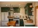 Bright kitchen featuring stylish green cabinetry, stainless steel appliances and lots of counterspace at 102 W Washington Ave, Gilbert, AZ 85233