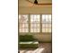 Sunlit living room featuring large windows and comfortable green seating with views to the outside at 102 W Washington Ave, Gilbert, AZ 85233
