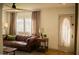 Cozy living room features a leather couch, decorative lamps and lots of natural light at 102 W Washington Ave, Gilbert, AZ 85233