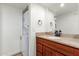 Bathroom featuring granite countertops, wood cabinetry, and a convenient stacked washer and dryer at 10610 S 48Th St # 2001, Phoenix, AZ 85044