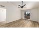 Bright bedroom featuring wood floors, a ceiling fan, and sliding doors leading to a private balcony with neighborhood views at 10610 S 48Th St # 2001, Phoenix, AZ 85044