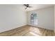 Bright bedroom showcasing wood floors, a ceiling fan, and a unique arched window providing ample natural light at 10610 S 48Th St # 2001, Phoenix, AZ 85044