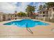 Sparkling community pool surrounded by lounge chairs and well-maintained landscaping at 10610 S 48Th St # 2001, Phoenix, AZ 85044