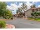 View of community buildings from street, featuring well-maintained landscaping and gated entry at 10610 S 48Th St # 2001, Phoenix, AZ 85044