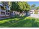 Scenic view of the lush, green community lawn surrounded by mature shade trees and well-maintained two-story buildings at 10610 S 48Th St # 2001, Phoenix, AZ 85044