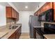 Efficient kitchen featuring stainless steel appliances, ample wood cabinets, and sleek countertops for a modern cooking experience at 10610 S 48Th St # 2001, Phoenix, AZ 85044