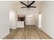 Spacious, open-concept living room with modern wood flooring, a ceiling fan, and easy access to a convenient kitchen at 10610 S 48Th St # 2001, Phoenix, AZ 85044
