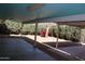 Back patio featuring covered concrete slabs and a tree at 10621 N 115Th Ave, Youngtown, AZ 85363