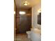 Bathroom featuring a glass-enclosed shower, toilet, and vanity with sink at 10621 N 115Th Ave, Youngtown, AZ 85363
