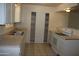 Practical kitchen with neutral countertops, bright white cabinets, and ample storage space at 10621 N 115Th Ave, Youngtown, AZ 85363