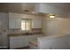Practical kitchen with neutral countertops, bright white cabinets, and ample storage space at 10621 N 115Th Ave, Youngtown, AZ 85363