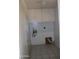 Functional laundry room with tile flooring and overhead cabinets at 10621 N 115Th Ave, Youngtown, AZ 85363