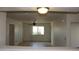 Bright and airy view into the living area of this home, showcasing natural light and a ceiling fan at 10621 N 115Th Ave, Youngtown, AZ 85363