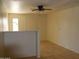 Open living room featuring tiled floors, a ceiling fan, and ample natural light at 10621 N 115Th Ave, Youngtown, AZ 85363