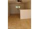 Spacious living room with a ceiling fan and tile flooring at 10621 N 115Th Ave, Youngtown, AZ 85363