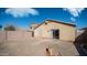 Back exterior of home with rock landscaping, patio, and sliding glass door at 10851 E Clovis Ave, Mesa, AZ 85208
