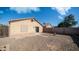 Back exterior of home with rock landscaping, patio, and sliding glass door at 10851 E Clovis Ave, Mesa, AZ 85208
