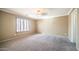 Spacious bedroom featuring carpeted floors, neutral paint, and a window with shutters at 10851 E Clovis Ave, Mesa, AZ 85208