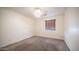 Neutral bedroom with carpeted floors, ceiling fan, and natural light from a window at 10851 E Clovis Ave, Mesa, AZ 85208
