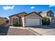 Charming single-story home with a two-car garage, low maintenance landscaping, and a cozy facade at 10851 E Clovis Ave, Mesa, AZ 85208
