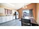 Bright kitchen with stainless steel appliances, white cabinets, and a cozy dining area with backyard access at 10851 E Clovis Ave, Mesa, AZ 85208