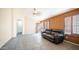 Inviting living room featuring tile floors, neutral paint, and a comfortable leather sofa at 10851 E Clovis Ave, Mesa, AZ 85208