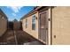 Home side exterior features secure gated access and low-maintenance desert landscaping for easy upkeep at 10851 E Clovis Ave, Mesa, AZ 85208