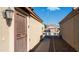 Home side exterior features secure gated access and low-maintenance desert landscaping for easy upkeep at 10851 E Clovis Ave, Mesa, AZ 85208
