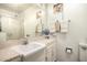 Bathroom vanity area with white basin sink, marble countertop and hardware at 10854 N Fairway E Ct, Sun City, AZ 85351