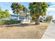 Charming single-story home featuring desert landscaping, white brick accents, and bright blue trim at 10922 W Peoria Ave, Sun City, AZ 85351