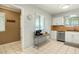 Bright kitchen featuring white cabinets, stainless steel appliances, and tiled floors at 10922 W Peoria Ave, Sun City, AZ 85351