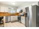 Modern kitchen featuring stainless appliances, white cabinets, and sleek countertops at 10922 W Peoria Ave, Sun City, AZ 85351