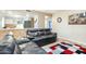 Cozy living room showcasing a comfortable leather couch and an opening looking into the kitchen at 10922 W Peoria Ave, Sun City, AZ 85351