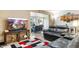 Inviting living room featuring a comfortable leather couch and a modern entertainment center at 10922 W Peoria Ave, Sun City, AZ 85351