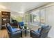 Bright sunroom featuring comfortable seating and views of the lush greenery at 10922 W Peoria Ave, Sun City, AZ 85351